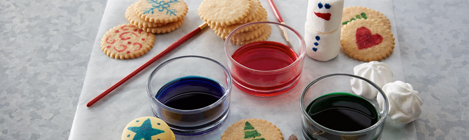 Painting with paint brushes on cookies